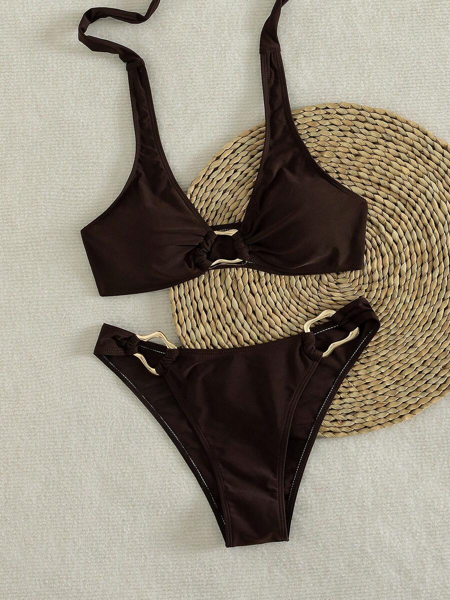 Women's 2-piece solid color halter bikini set featuring a backless tie-back wireless top and mid-waist swimsuit bottoms.