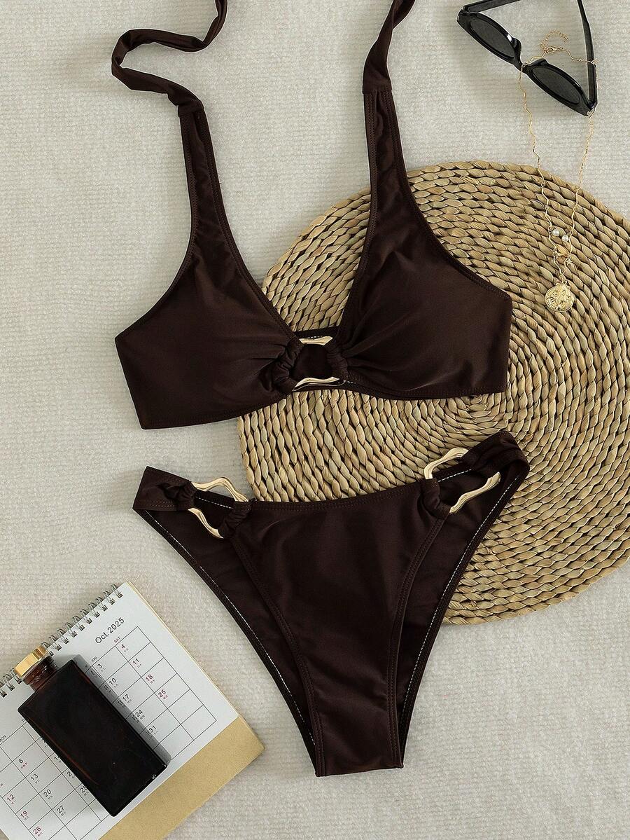 Women's 2-piece solid color halter bikini set featuring a backless tie-back wireless top and mid-waist swimsuit bottoms.