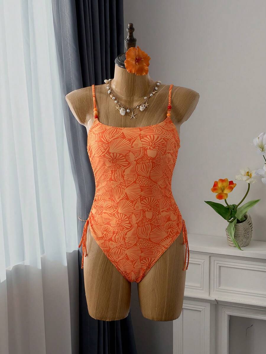 Women's blue backless one-piece swimsuit featuring spaghetti straps, wireless bra with removable padding, and drawstring details.