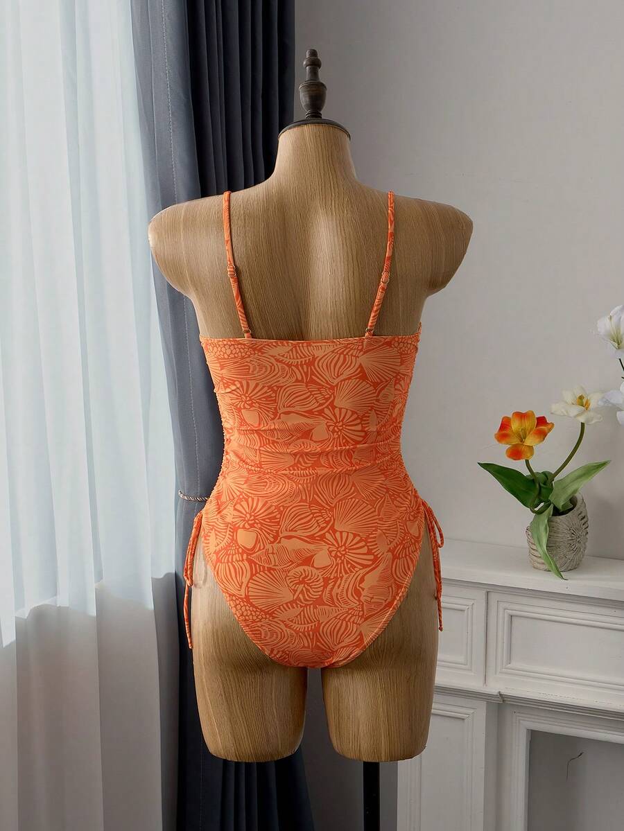 Women's blue backless one-piece swimsuit featuring spaghetti straps, wireless bra with removable padding, and drawstring details.