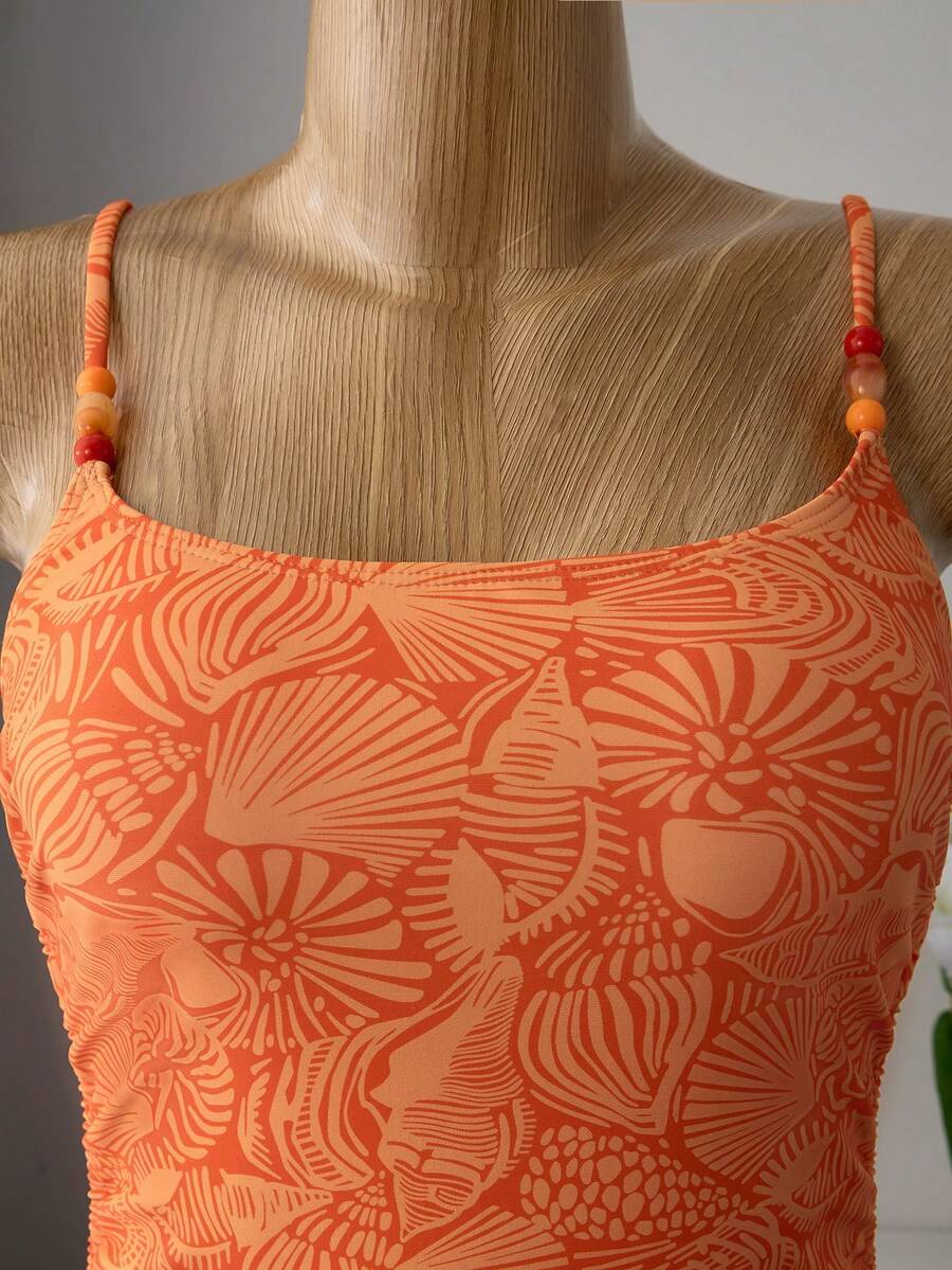 Women's blue backless one-piece swimsuit featuring spaghetti straps, wireless bra with removable padding, and drawstring details.
