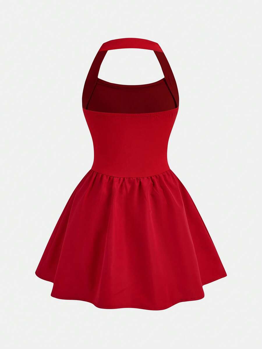 Black sleeveless halter polka dot mini dress for tween girls featuring a high waist and flared hem