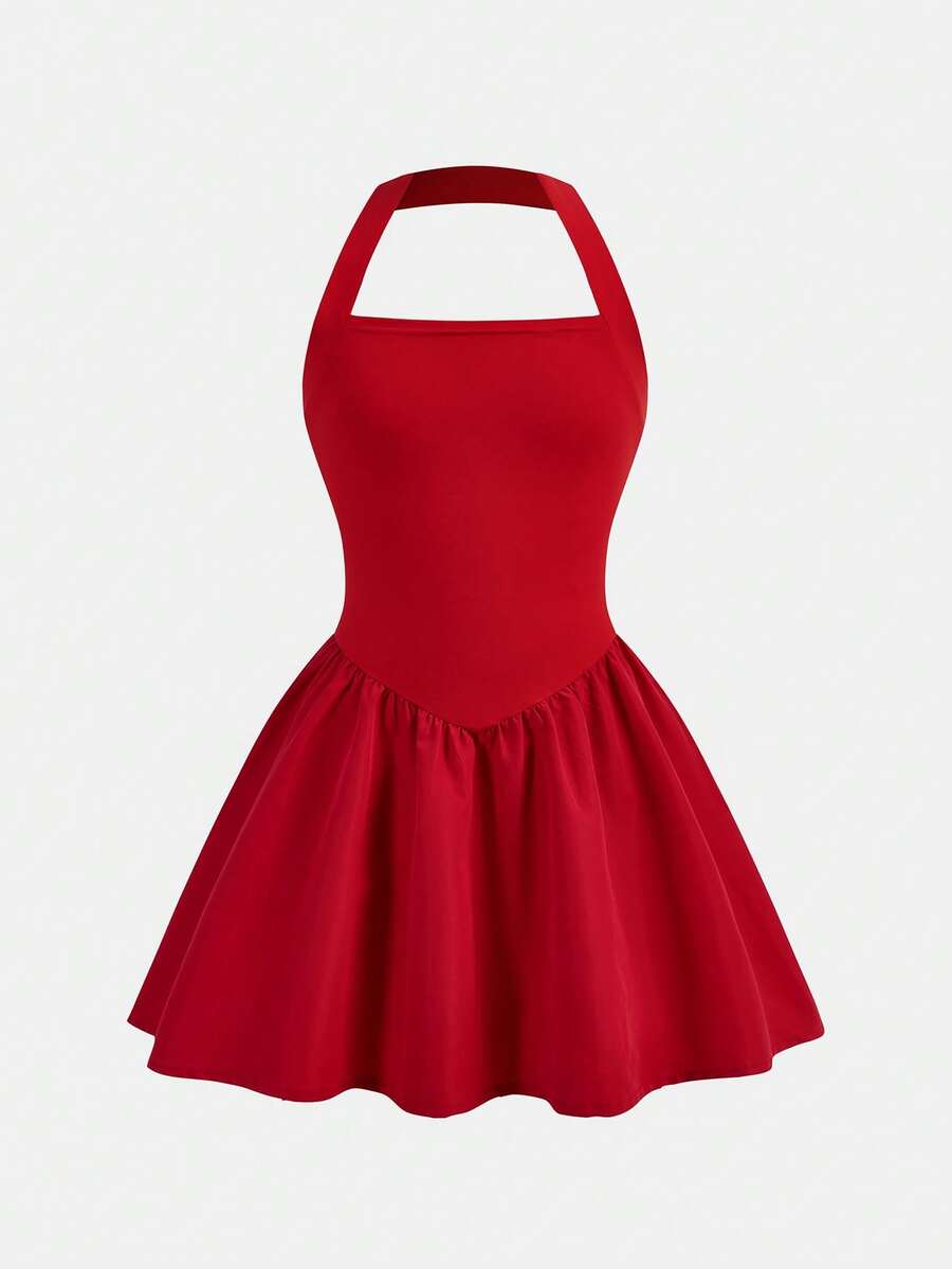 Black sleeveless halter polka dot mini dress for tween girls featuring a high waist and flared hem