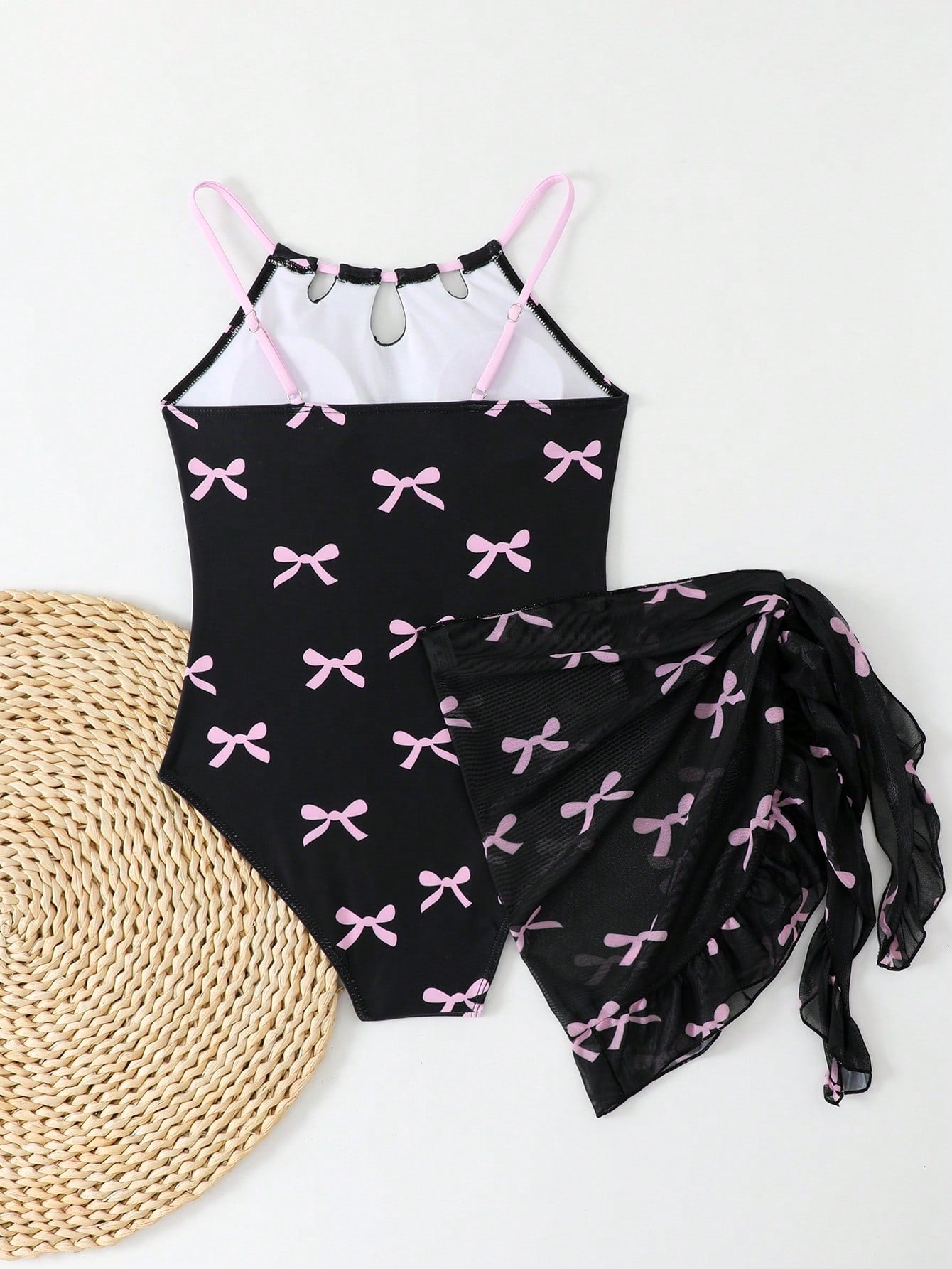 Girls black and white one-piece swimsuit set with cut-out detail, spaghetti straps, sleeveless fitted design, and matching skirt bottom for vacation swimwear.