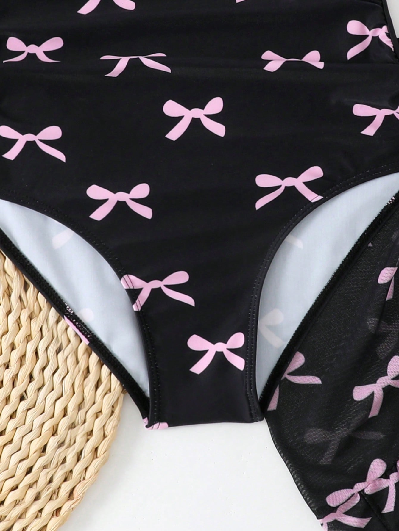 Girls black and white one-piece swimsuit set with cut-out detail, spaghetti straps, sleeveless fitted design, and matching skirt bottom for vacation swimwear.