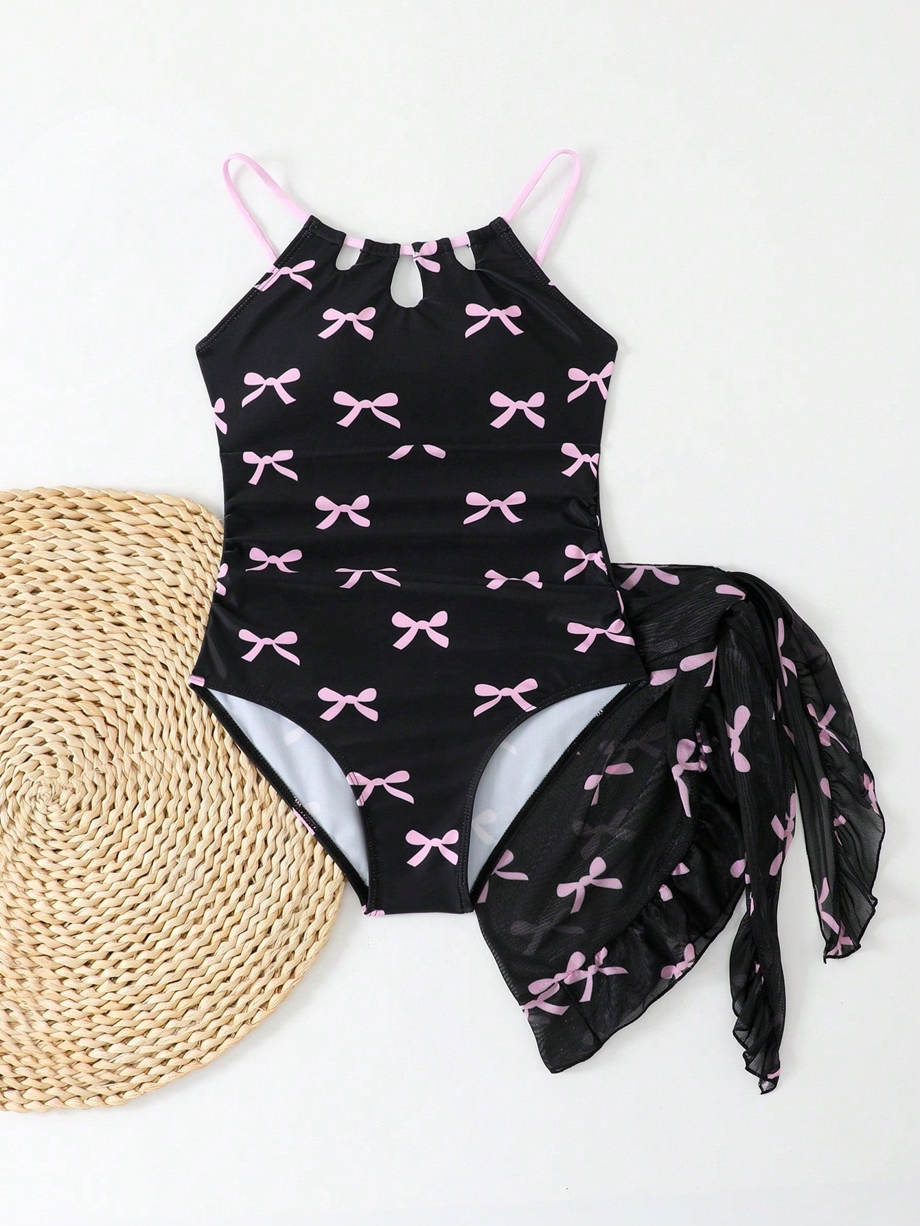 Girls black and white one-piece swimsuit set with cut-out detail, spaghetti straps, sleeveless fitted design, and matching skirt bottom for vacation swimwear.