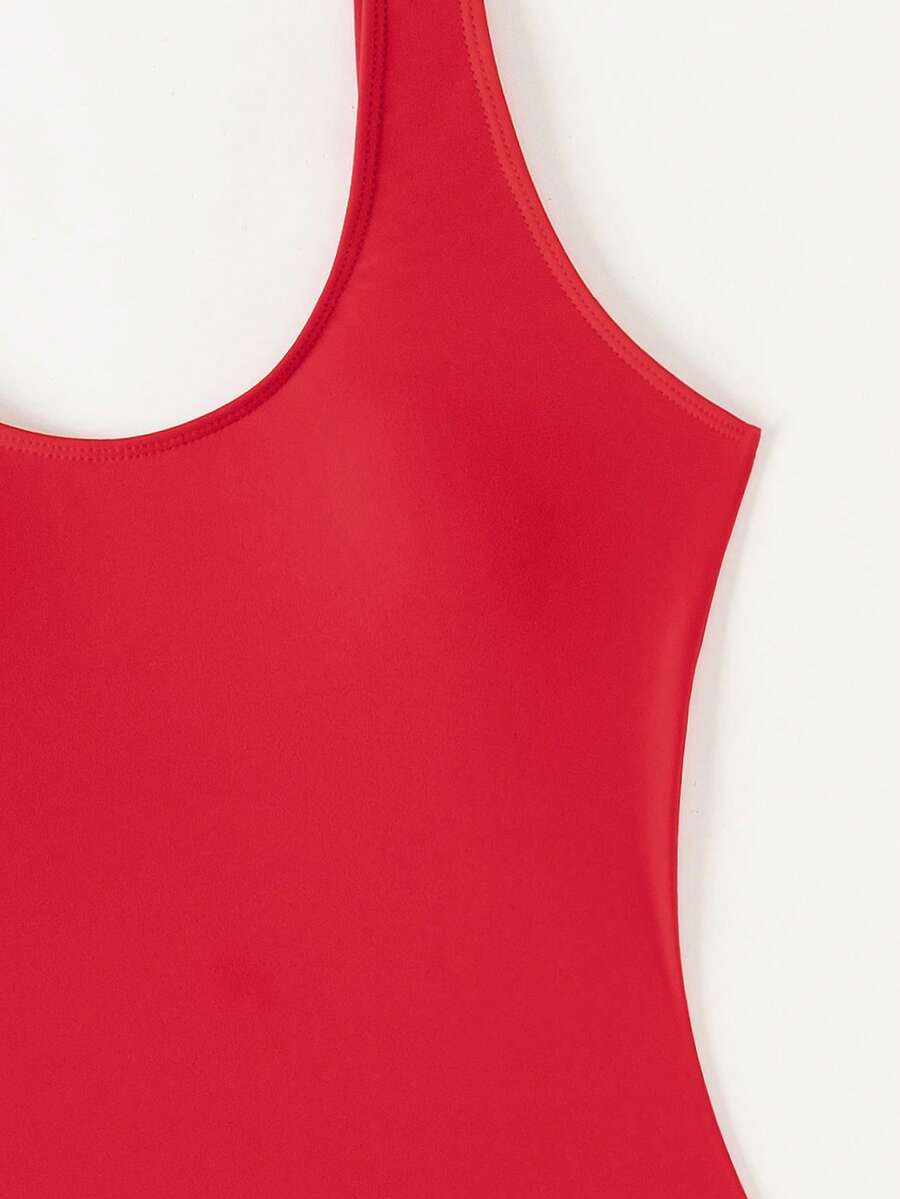 Women's solid color one-piece swimsuit featuring a backless scoop neck design and high cut fit