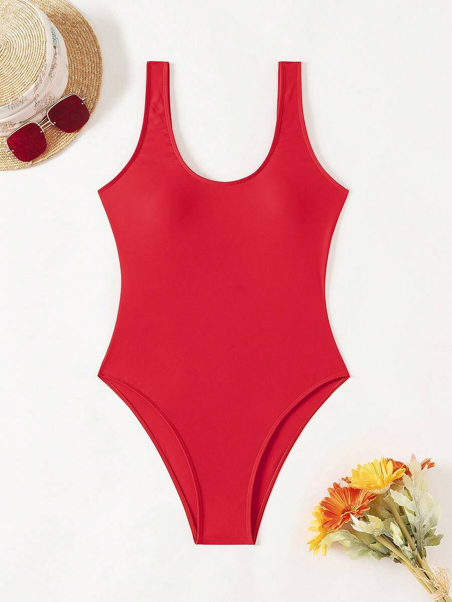 Women's solid color one-piece swimsuit featuring a backless scoop neck design and high cut fit