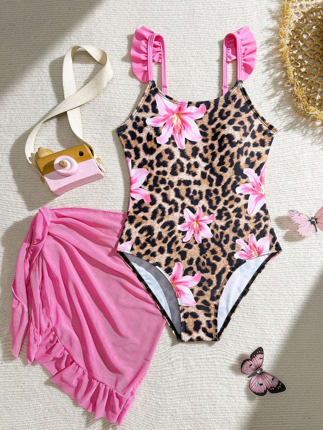 Tween girls one-piece swimsuit in leopard print with ruffle shoulder straps, scoop neckline, fitted shape, and attached ruffle hem skirt; sleeveless, mid-waist skirt bottom, and lined body for swimming, vacation, and summer beach wear.