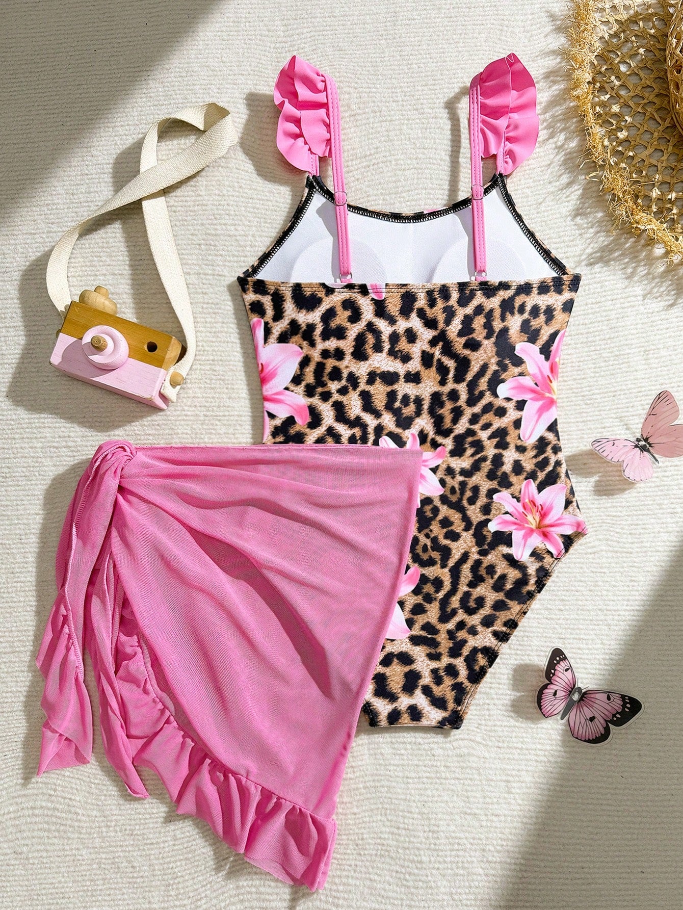 Tween girls one-piece swimsuit in leopard print with ruffle shoulder straps, scoop neckline, fitted shape, and attached ruffle hem skirt; sleeveless, mid-waist skirt bottom, and lined body for swimming, vacation, and summer beach wear.