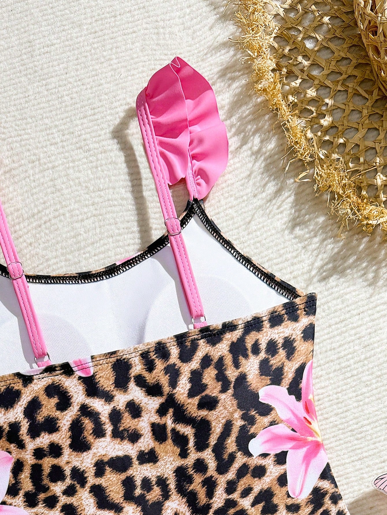 Tween girls one-piece swimsuit in leopard print with ruffle shoulder straps, scoop neckline, fitted shape, and attached ruffle hem skirt; sleeveless, mid-waist skirt bottom, and lined body for swimming, vacation, and summer beach wear.