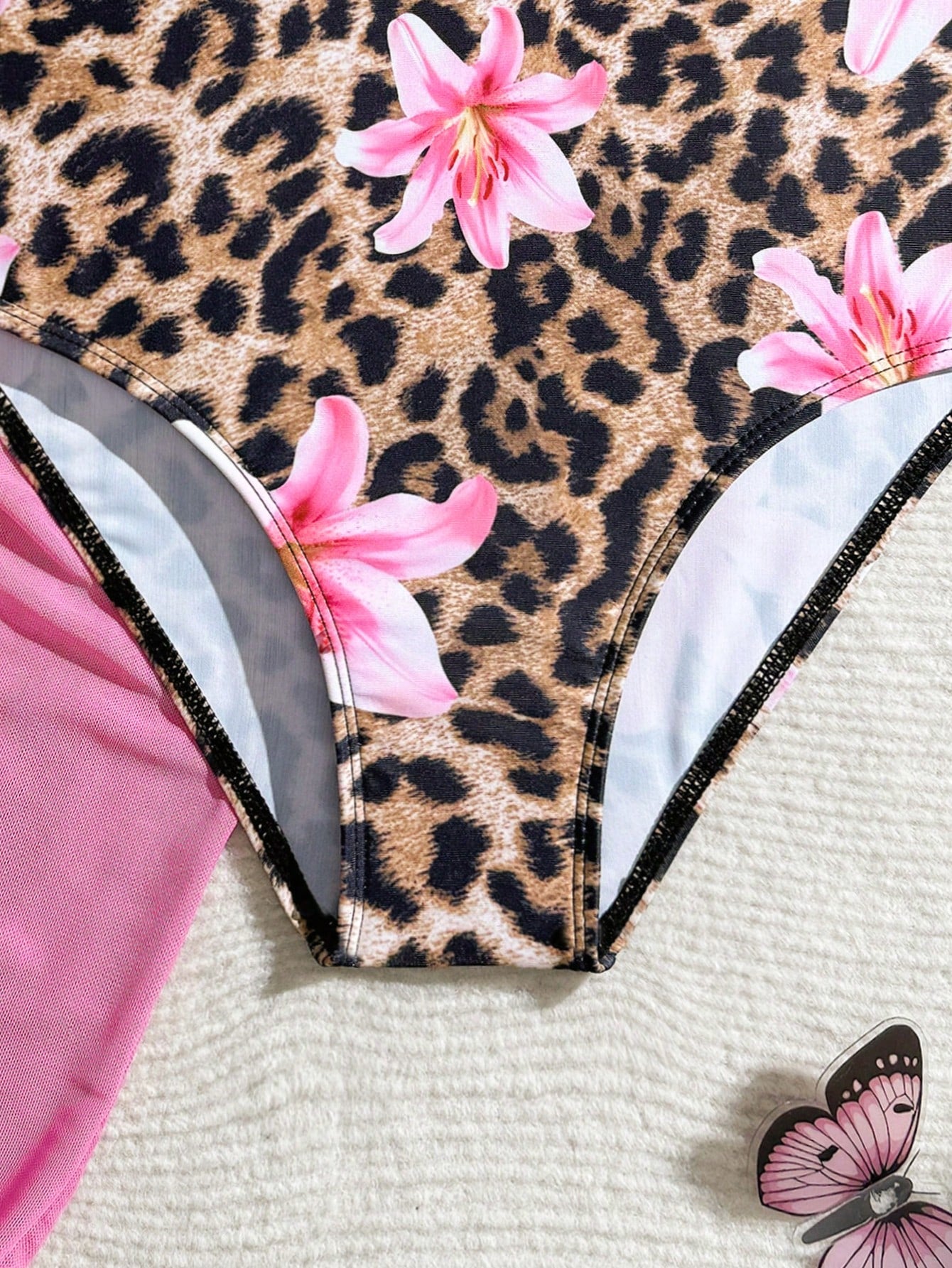 Tween girls one-piece swimsuit in leopard print with ruffle shoulder straps, scoop neckline, fitted shape, and attached ruffle hem skirt; sleeveless, mid-waist skirt bottom, and lined body for swimming, vacation, and summer beach wear.