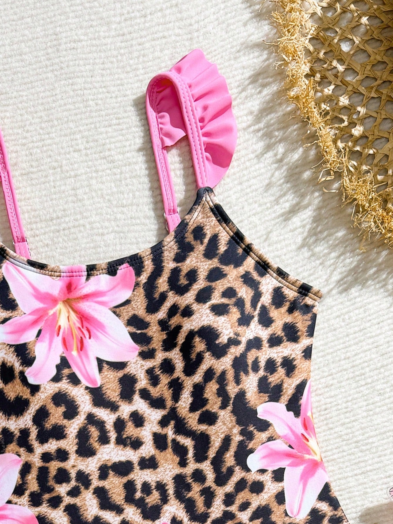 Tween girls one-piece swimsuit in leopard print with ruffle shoulder straps, scoop neckline, fitted shape, and attached ruffle hem skirt; sleeveless, mid-waist skirt bottom, and lined body for swimming, vacation, and summer beach wear.