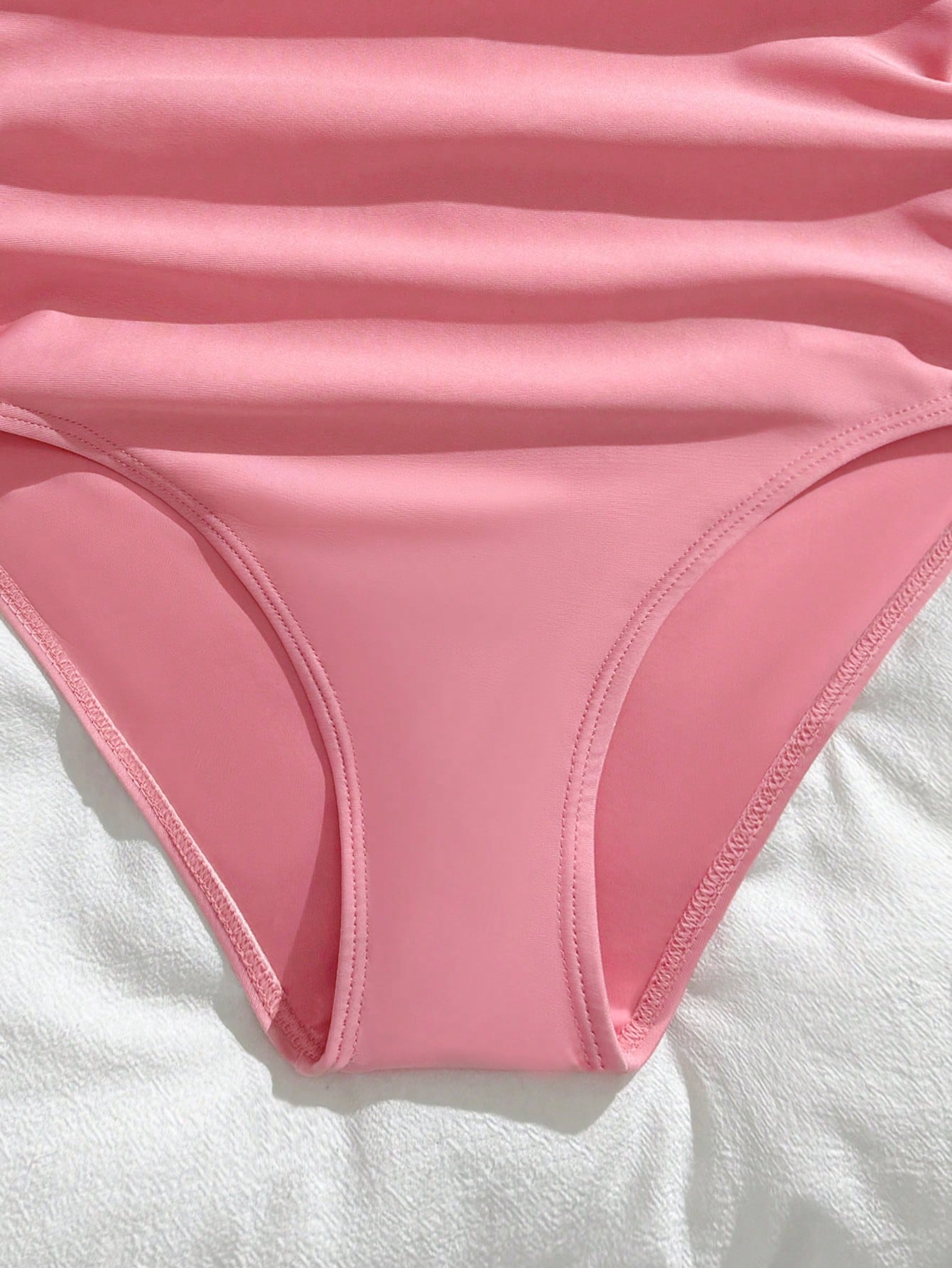 Purple rib knit one-piece swimsuit for tween girls with spaghetti straps, fitted shape, mid-waist bottom, wireless bra, and lined body.