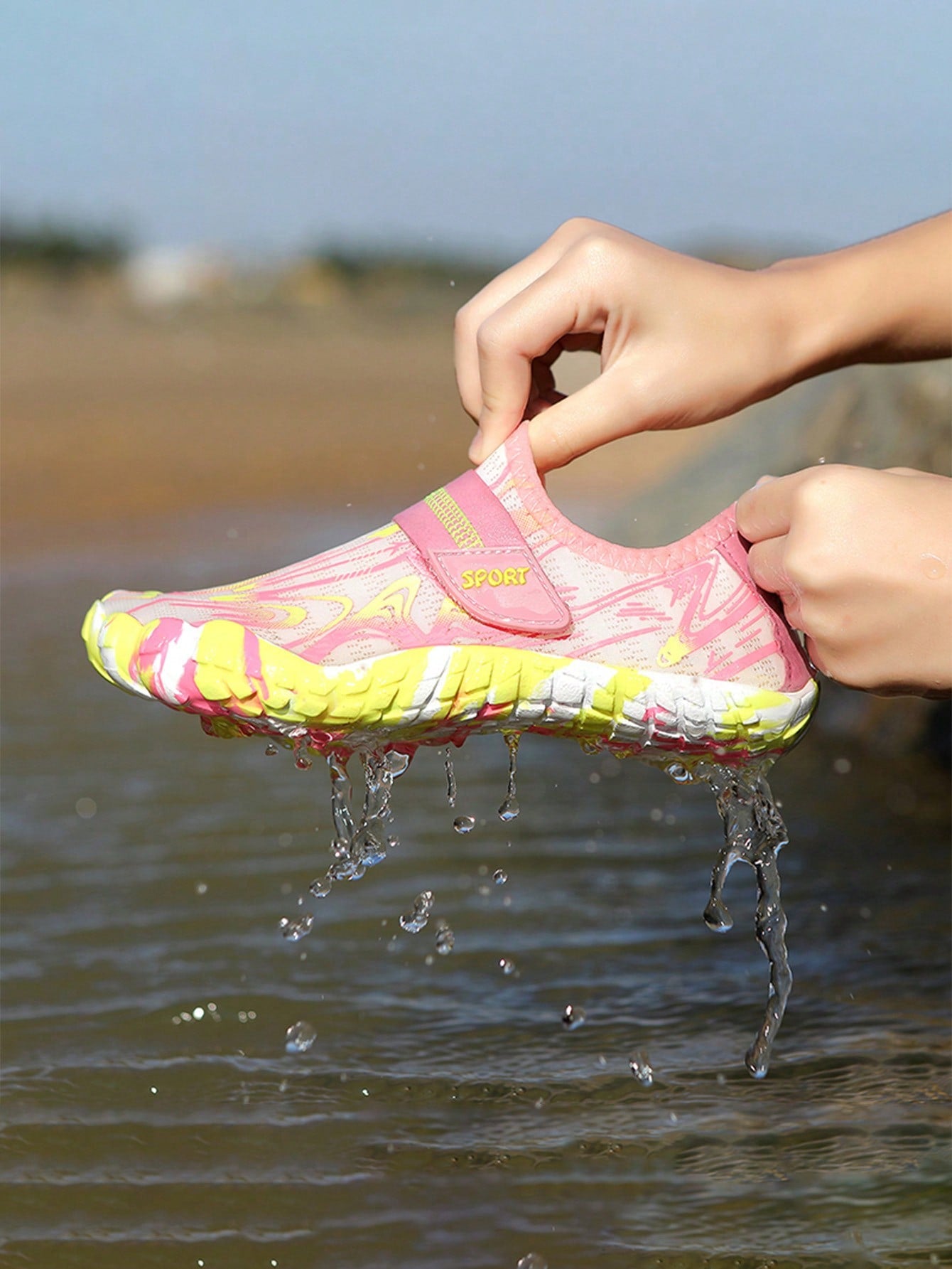 Children's water shoes featuring a breathable mesh upper, hook and loop closure, luminous details, and a non-slip outsole for boys and girls.