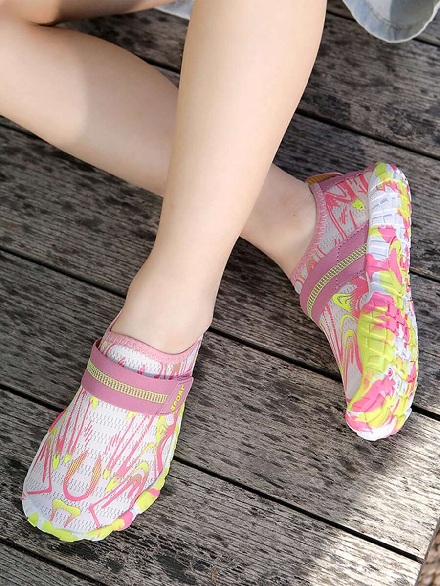 Children's water shoes featuring a breathable mesh upper, hook and loop closure, luminous details, and a non-slip outsole for boys and girls.