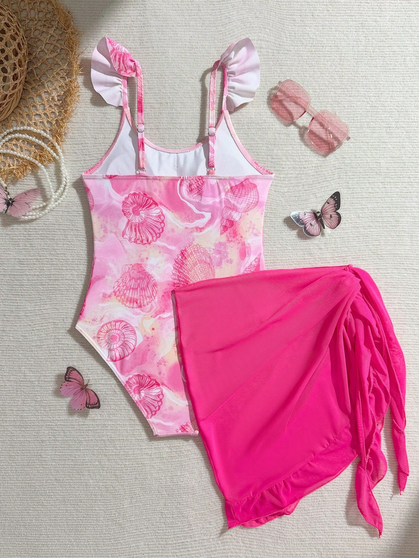Tween girls one-piece swimsuit in leopard print with ruffle shoulder straps, scoop neckline, fitted shape, and attached ruffle hem skirt; sleeveless, mid-waist skirt bottom, and lined body for swimming, vacation, and summer beach wear.