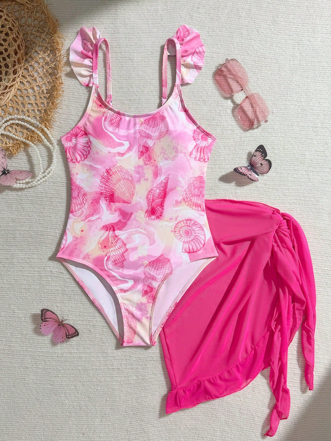 Tween girls one-piece swimsuit in leopard print with ruffle shoulder straps, scoop neckline, fitted shape, and attached ruffle hem skirt; sleeveless, mid-waist skirt bottom, and lined body for swimming, vacation, and summer beach wear.