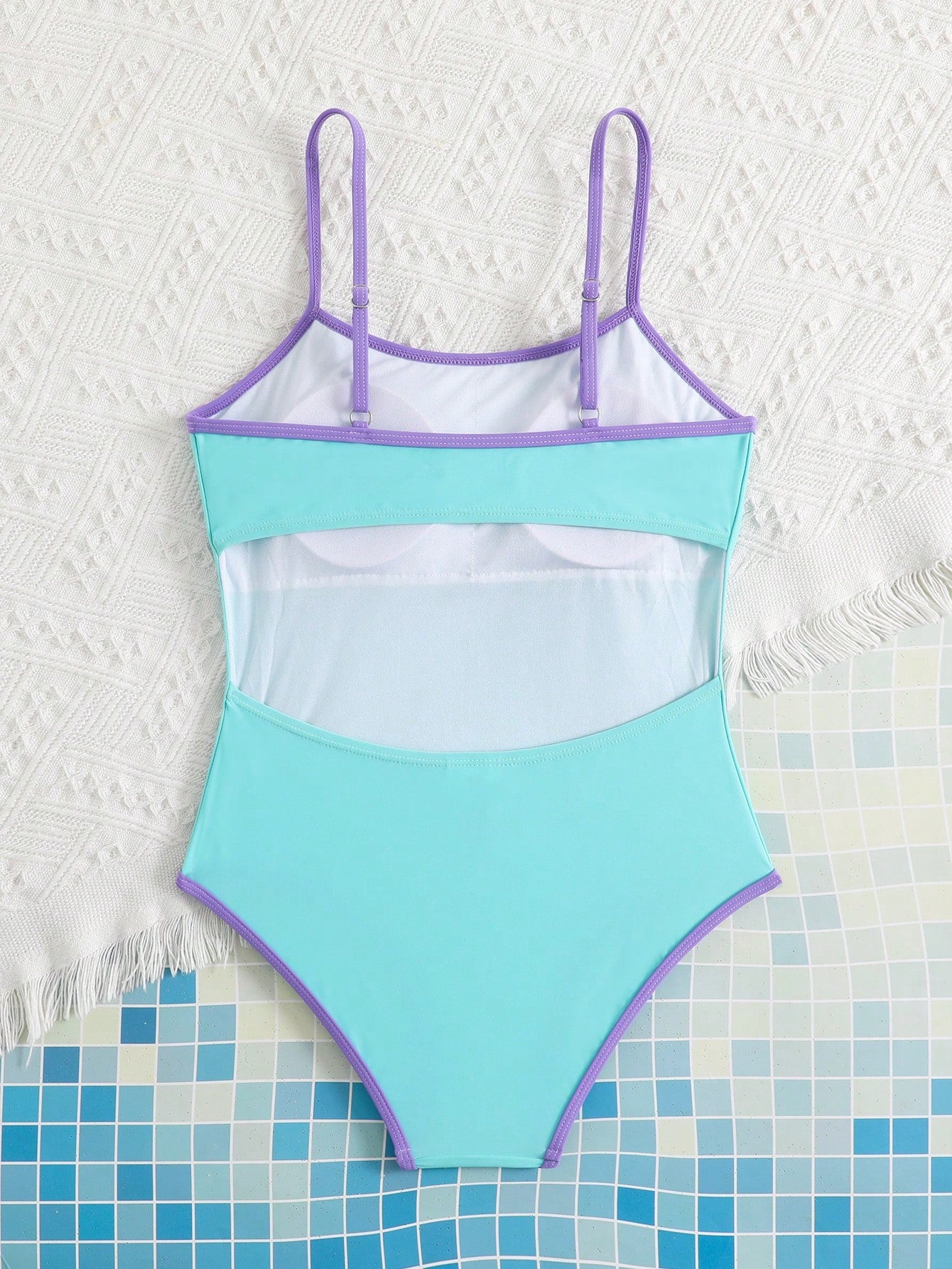 Tween girls one-piece swimsuit with a floral plant print, spaghetti straps, and a mid-waist fit in black.