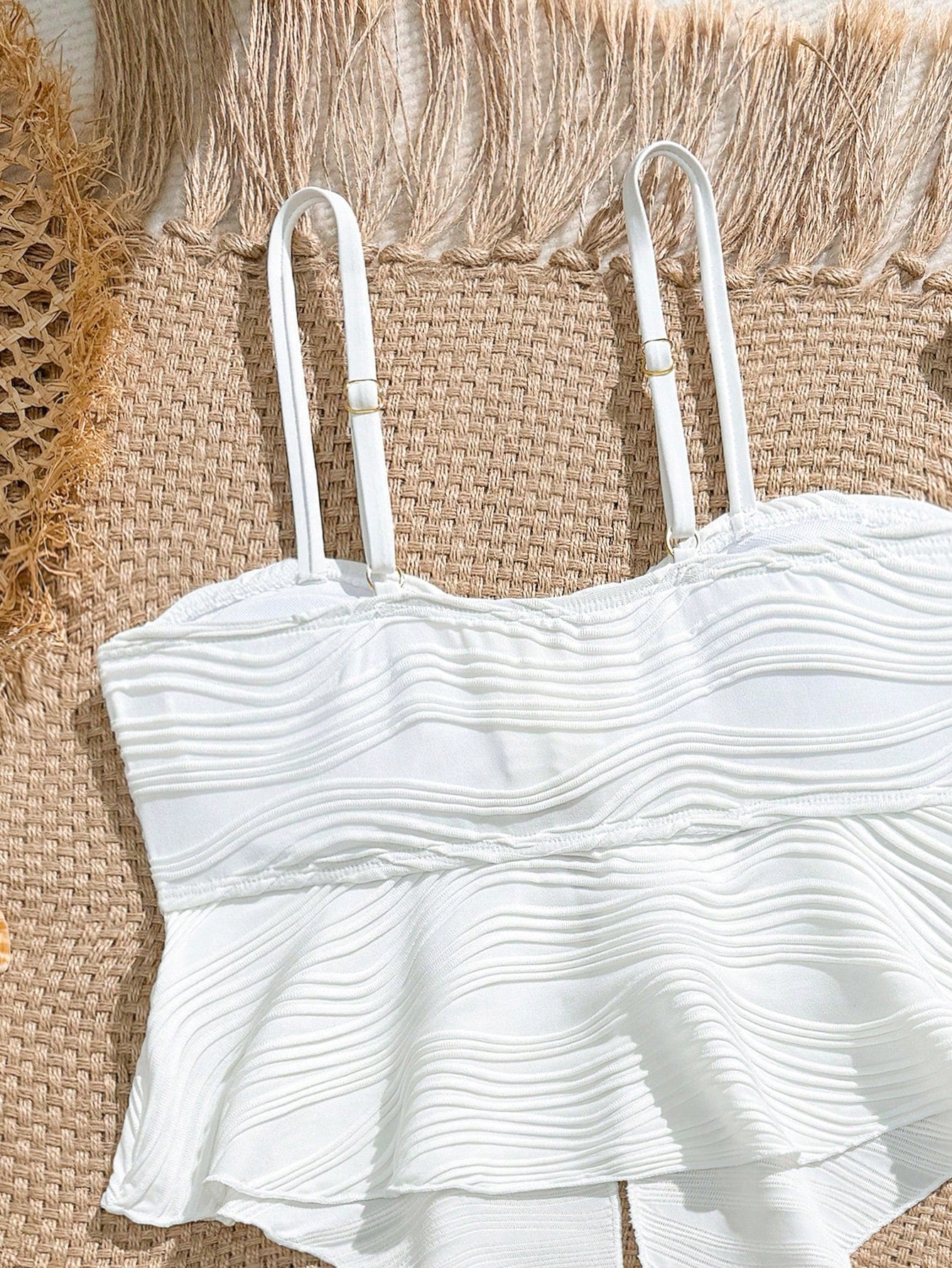 Tween girls 2-piece tankini swimwear set in apricot with a textured jacquard look, asymmetrical spaghetti-strap sleeveless top, and matching mid-waist short bikini bottoms.