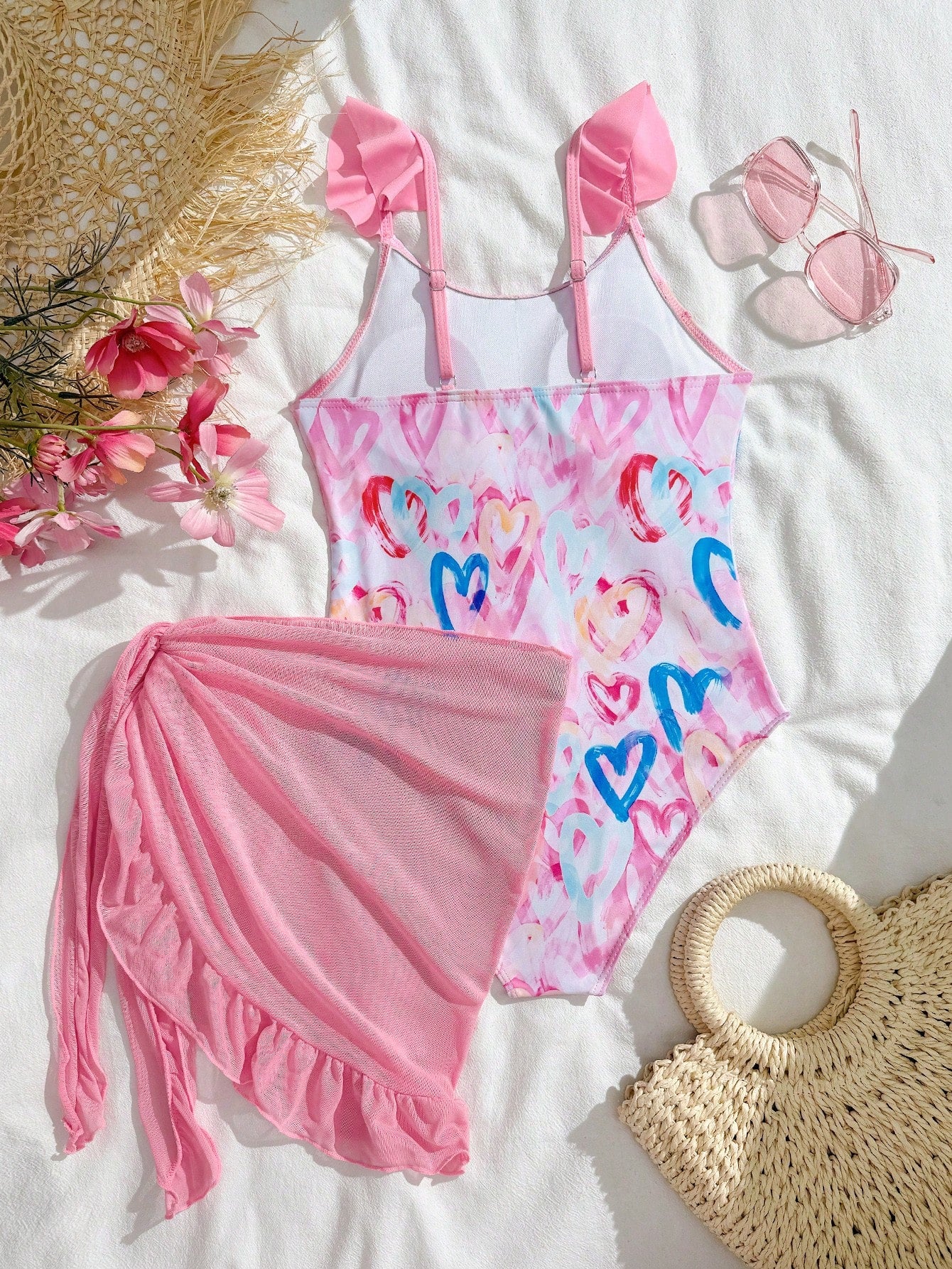 Tween girls one-piece swimsuit in leopard print with ruffle shoulder straps, scoop neckline, fitted shape, and attached ruffle hem skirt; sleeveless, mid-waist skirt bottom, and lined body for swimming, vacation, and summer beach wear.