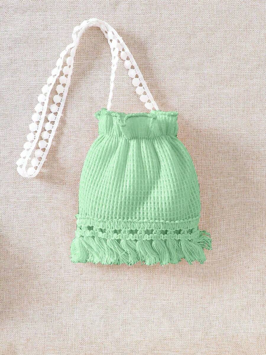 Girls' sleeveless summer midi dress with halter neckline, geometric pattern, applique and fringe details, shown with crossbody bag accessory with tassel decor