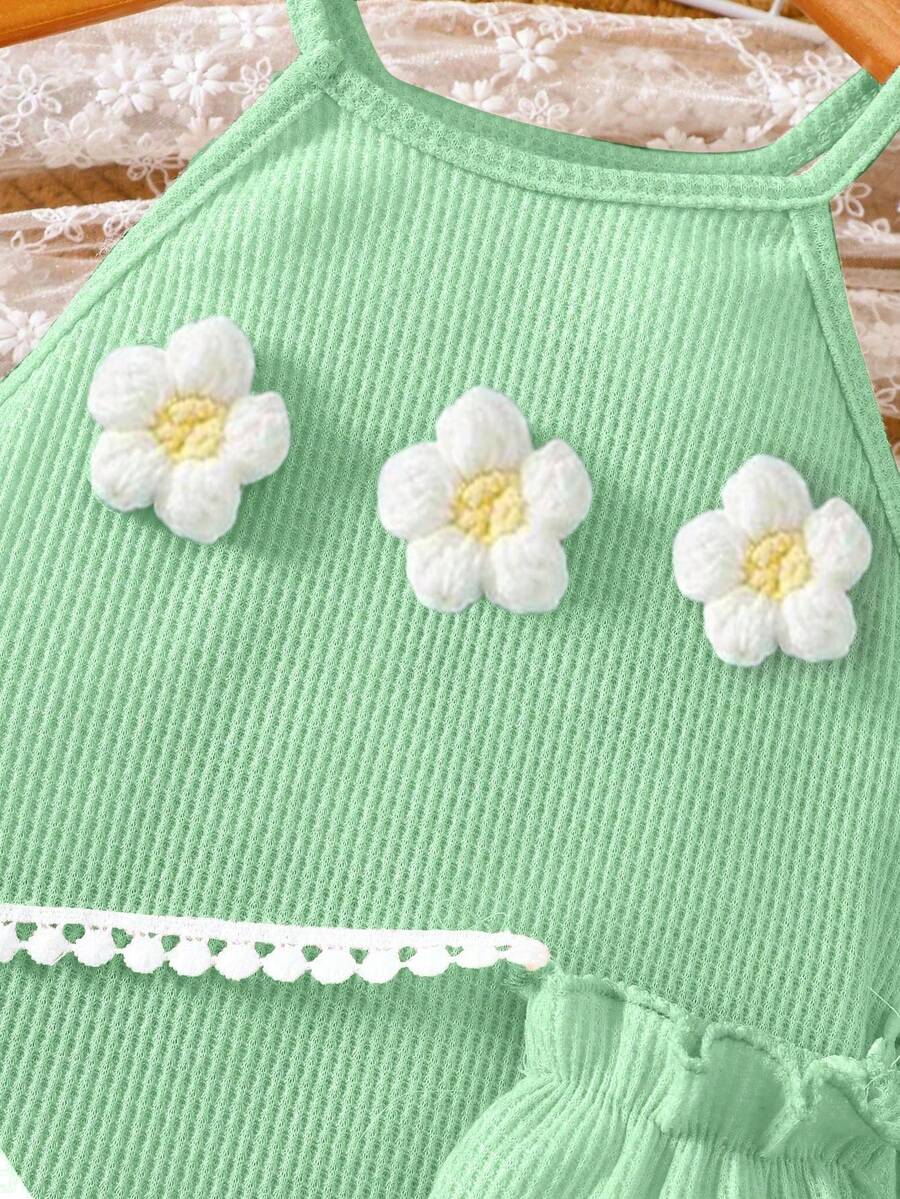 Girls' sleeveless summer midi dress with halter neckline, geometric pattern, applique and fringe details, shown with crossbody bag accessory with tassel decor