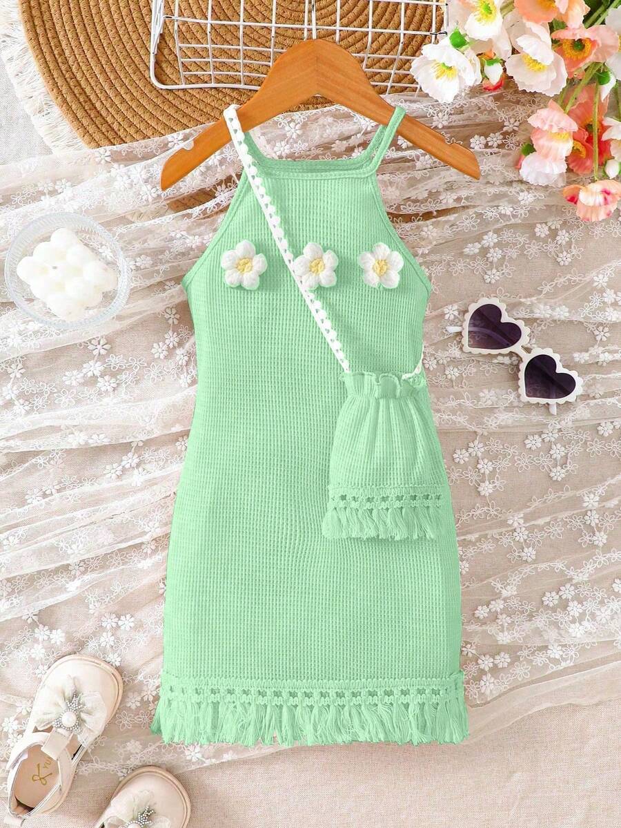 Girls' sleeveless summer midi dress with halter neckline, geometric pattern, applique and fringe details, shown with crossbody bag accessory with tassel decor