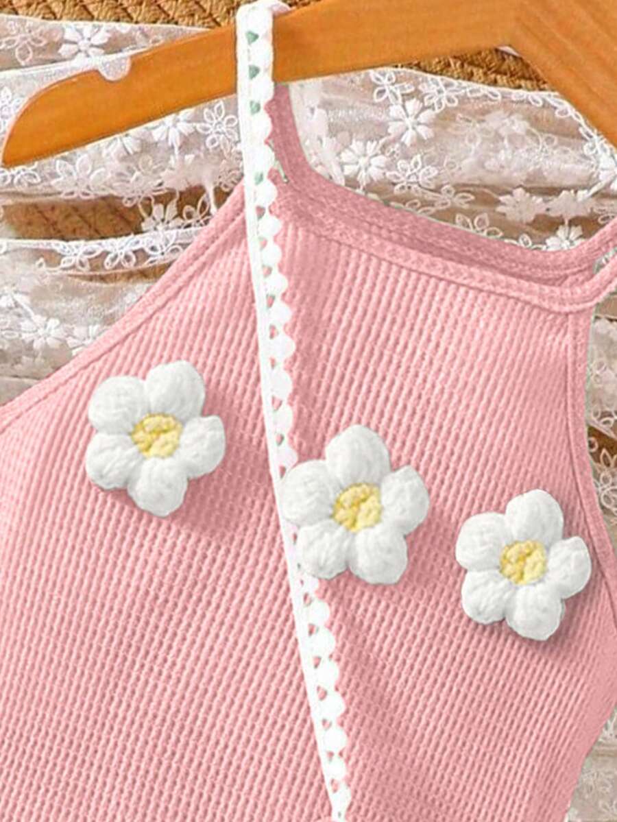 Girls' sleeveless summer midi dress with halter neckline, geometric pattern, applique and fringe details, shown with crossbody bag accessory with tassel decor