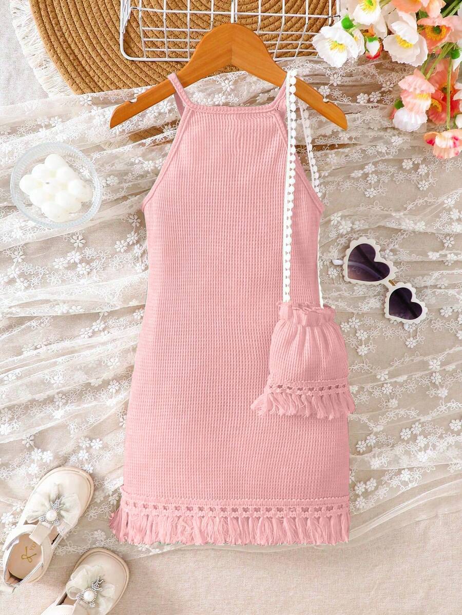 Girls' sleeveless summer midi dress with halter neckline, geometric pattern, applique and fringe details, shown with crossbody bag accessory with tassel decor