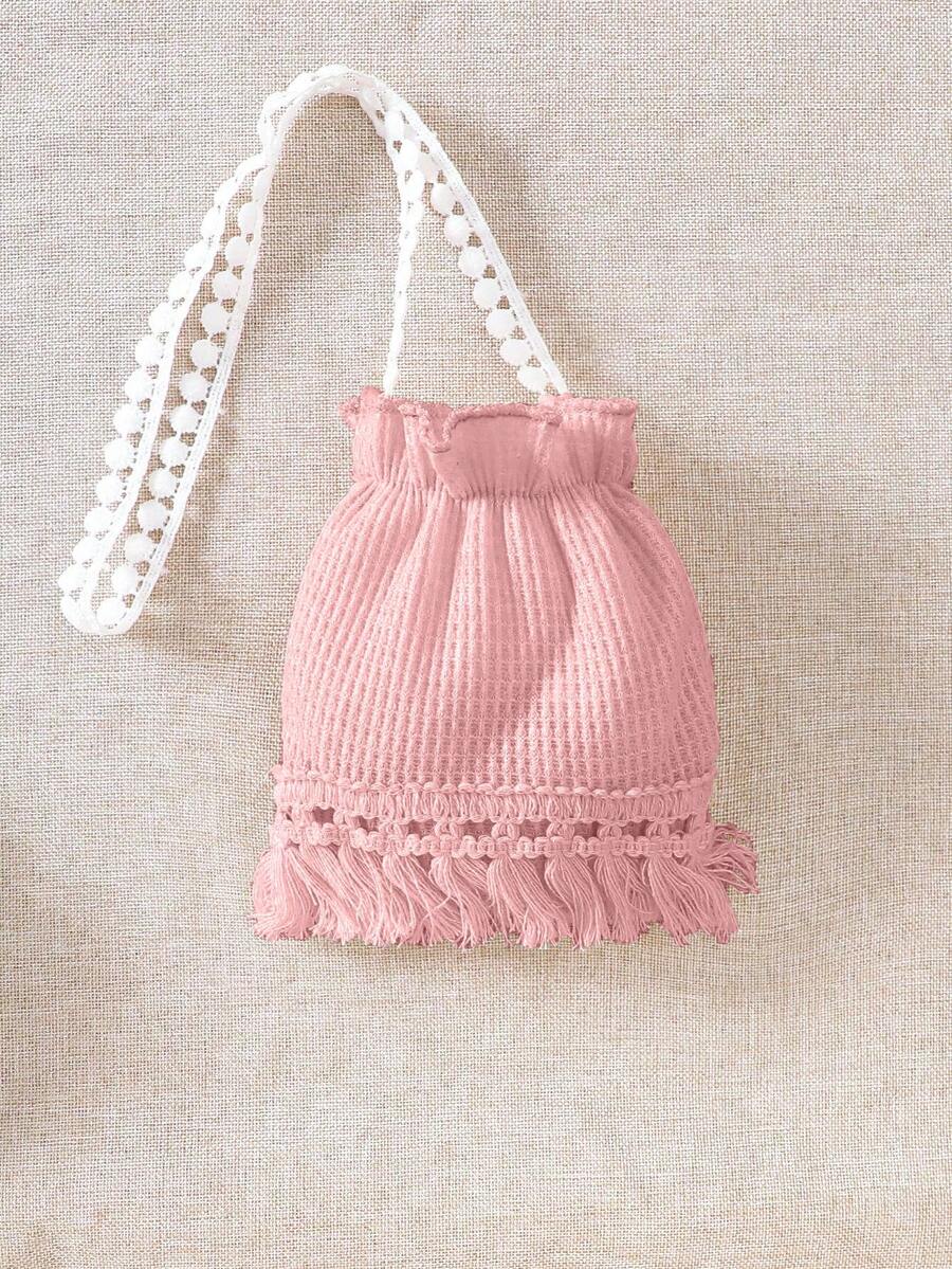 Girls' sleeveless summer midi dress with halter neckline, geometric pattern, applique and fringe details, shown with crossbody bag accessory with tassel decor