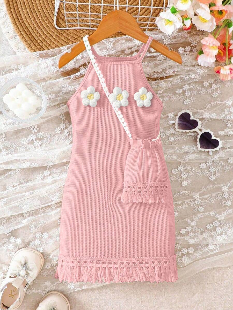 Girls' sleeveless summer midi dress with halter neckline, geometric pattern, applique and fringe details, shown with crossbody bag accessory with tassel decor