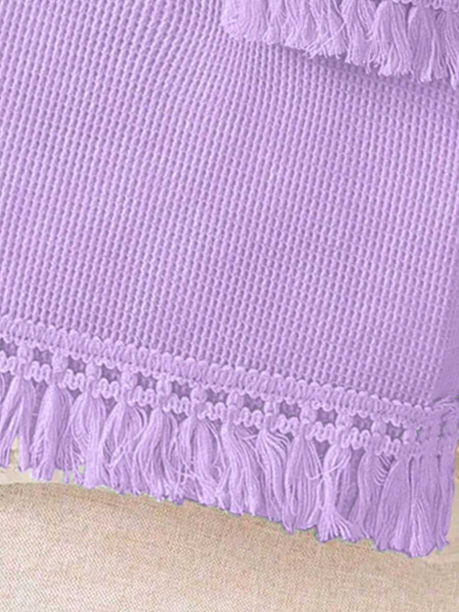 Girls' sleeveless summer midi dress with halter neckline, geometric pattern, applique and fringe details, shown with crossbody bag accessory with tassel decor
