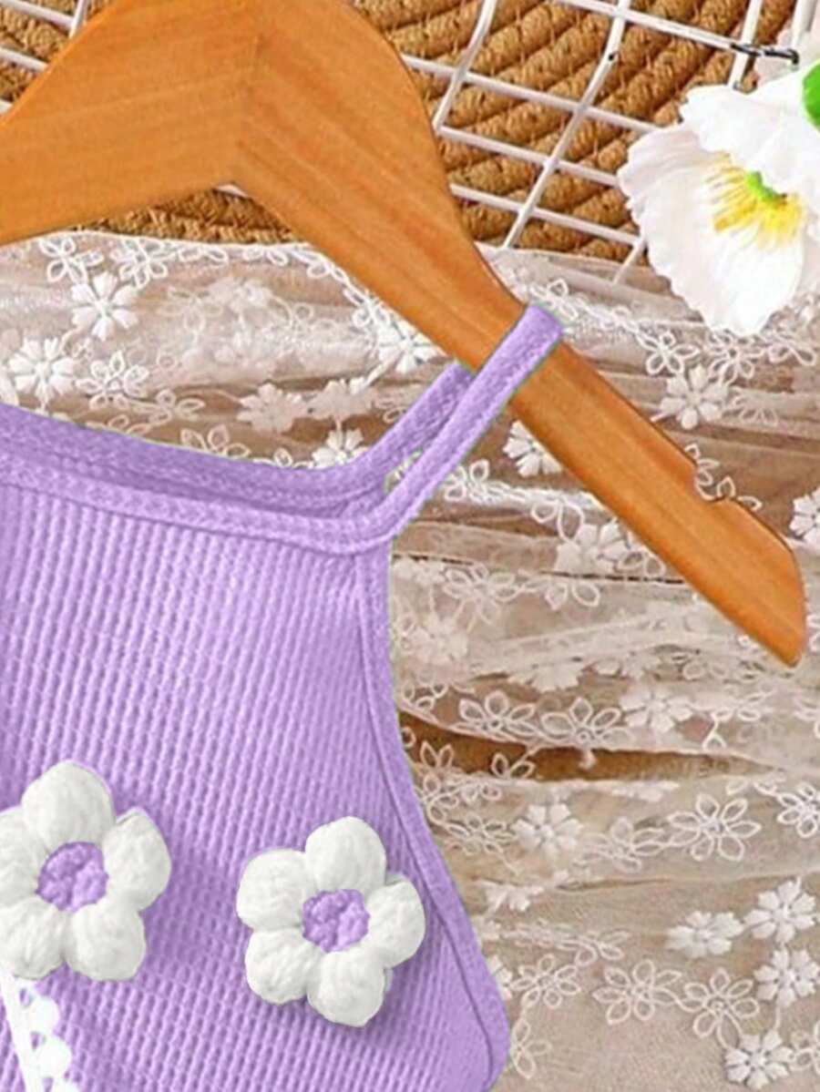 Girls' sleeveless summer midi dress with halter neckline, geometric pattern, applique and fringe details, shown with crossbody bag accessory with tassel decor