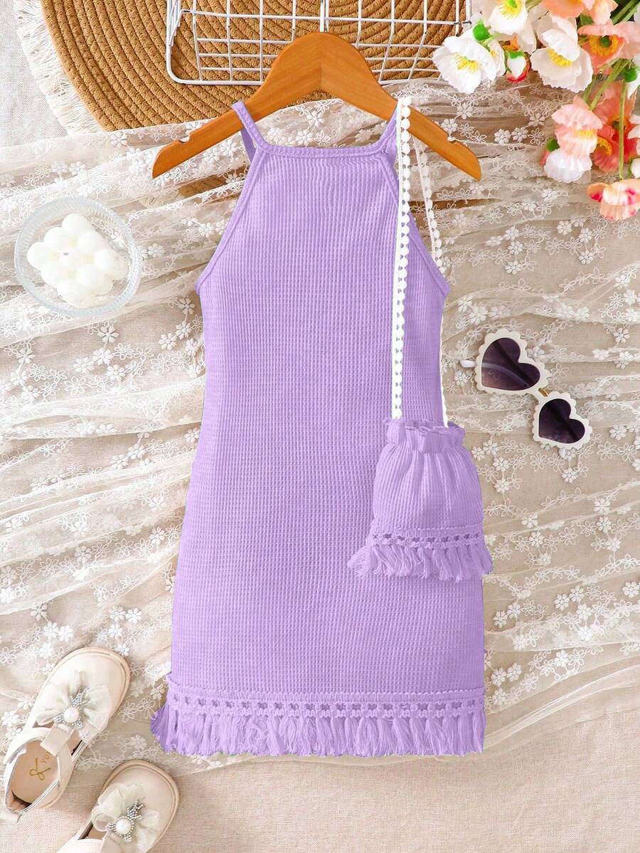 Girls' sleeveless summer midi dress with halter neckline, geometric pattern, applique and fringe details, shown with crossbody bag accessory with tassel decor
