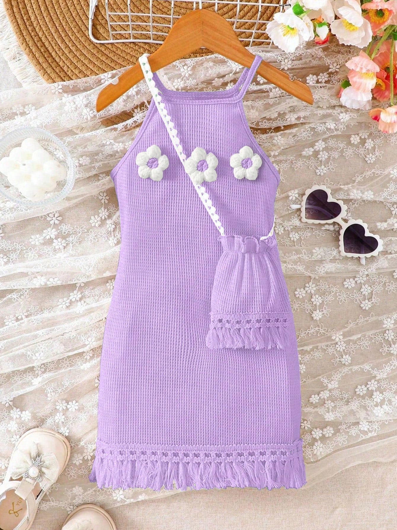 Girls' sleeveless summer midi dress with halter neckline, geometric pattern, applique and fringe details, shown with crossbody bag accessory with tassel decor