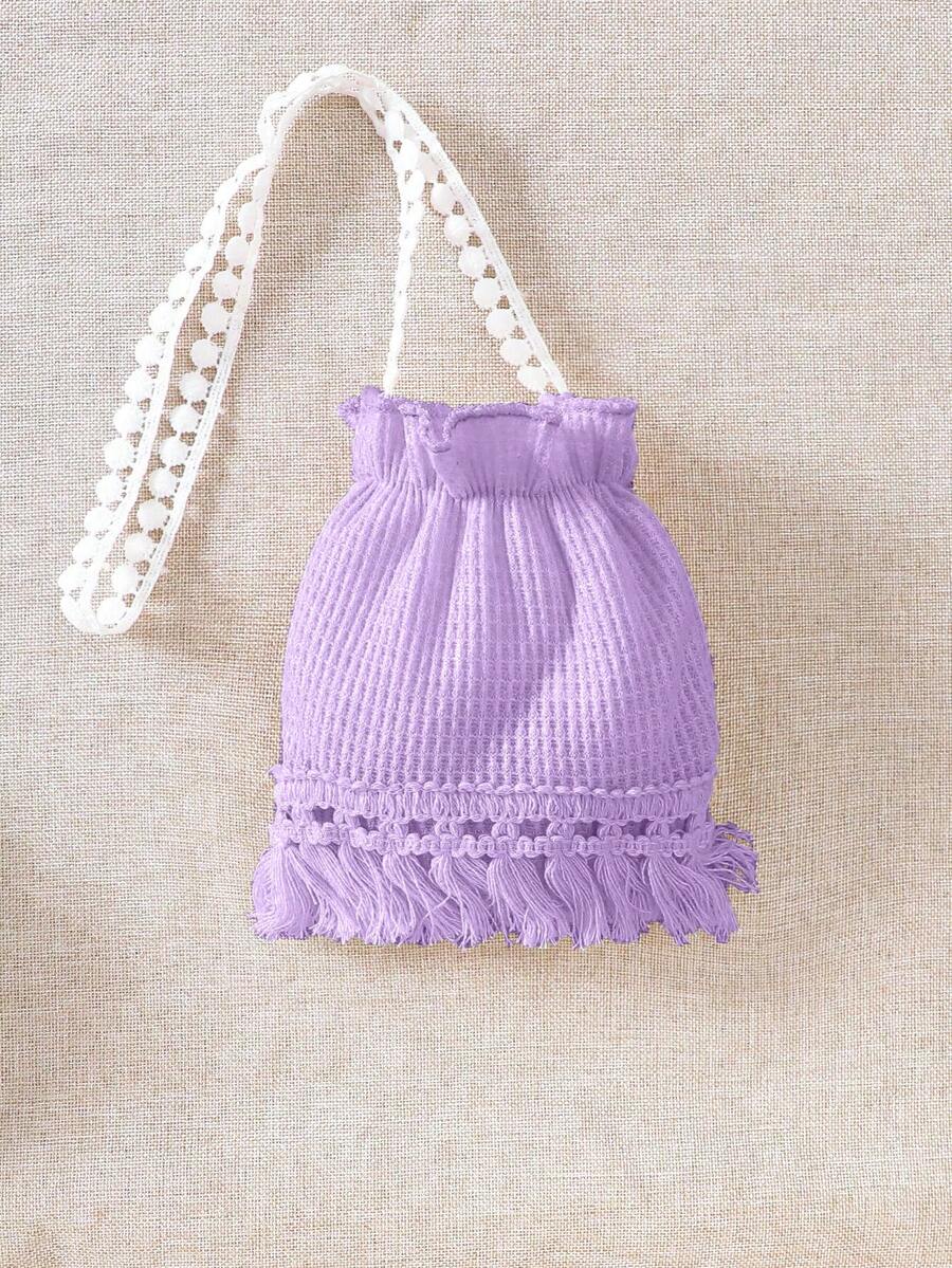 Girls' sleeveless summer midi dress with halter neckline, geometric pattern, applique and fringe details, shown with crossbody bag accessory with tassel decor