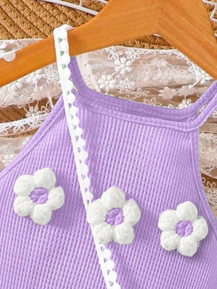 Girls' sleeveless summer midi dress with halter neckline, geometric pattern, applique and fringe details, shown with crossbody bag accessory with tassel decor