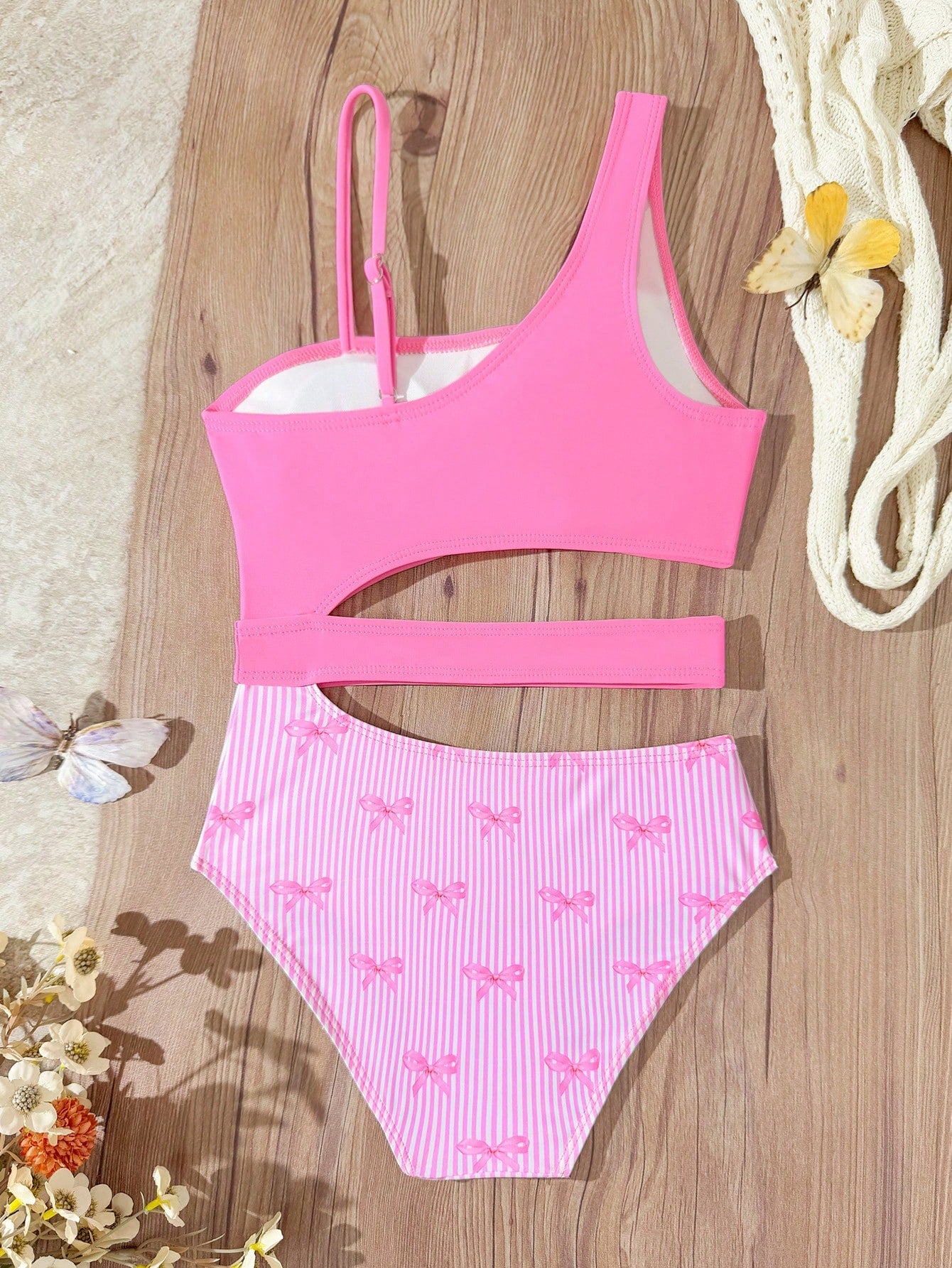Purple tween girls one-piece swimsuit with asymmetrical neckline, cut-out waist, striped pattern, fitted silhouette, and lined body.