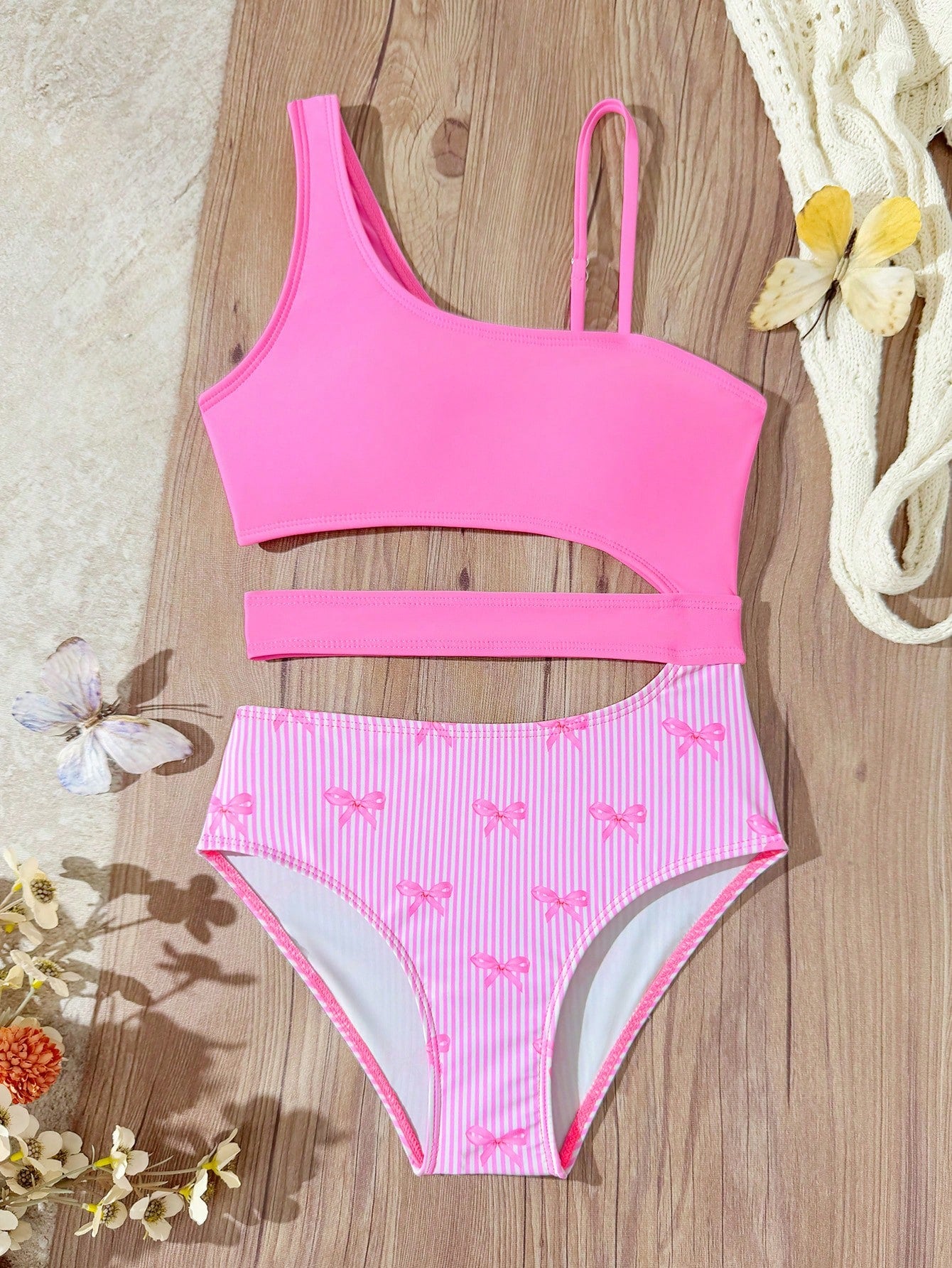 Purple tween girls one-piece swimsuit with asymmetrical neckline, cut-out waist, striped pattern, fitted silhouette, and lined body.