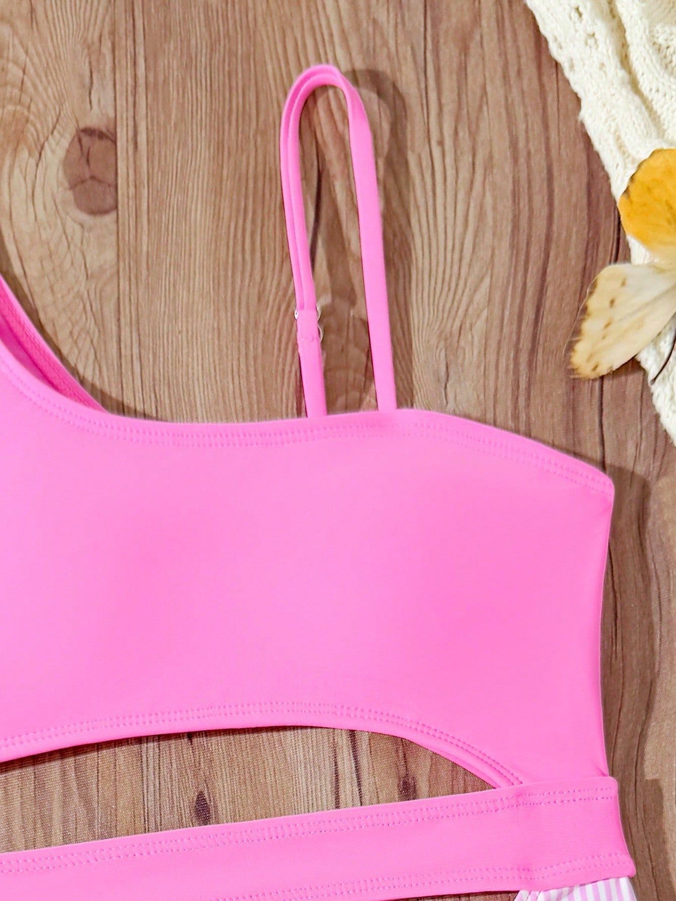 Purple tween girls one-piece swimsuit with asymmetrical neckline, cut-out waist, striped pattern, fitted silhouette, and lined body.