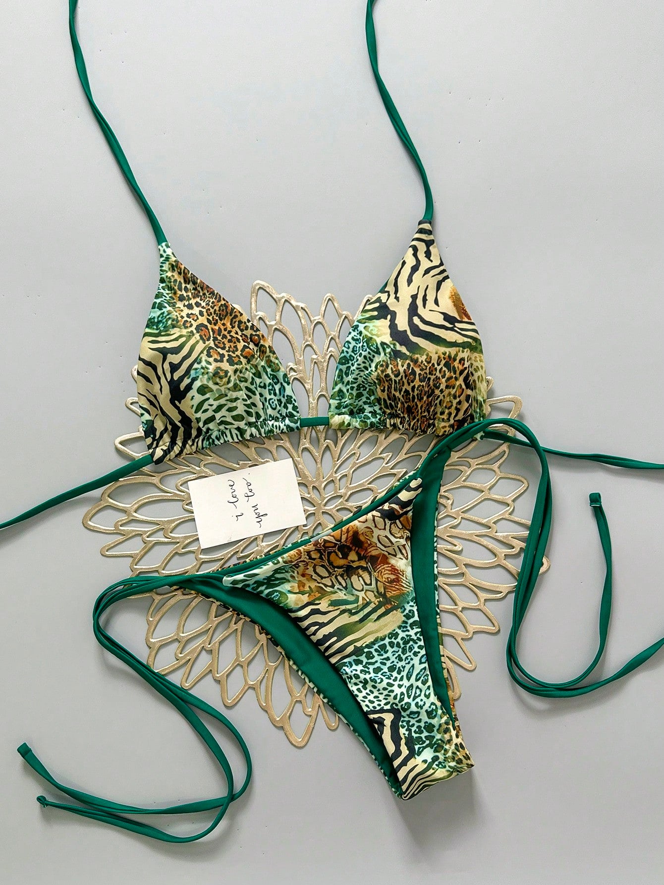 Women's vintage leopard print 2-piece bikini set featuring a high waist tie-side bottom and a halter neck triangle top.