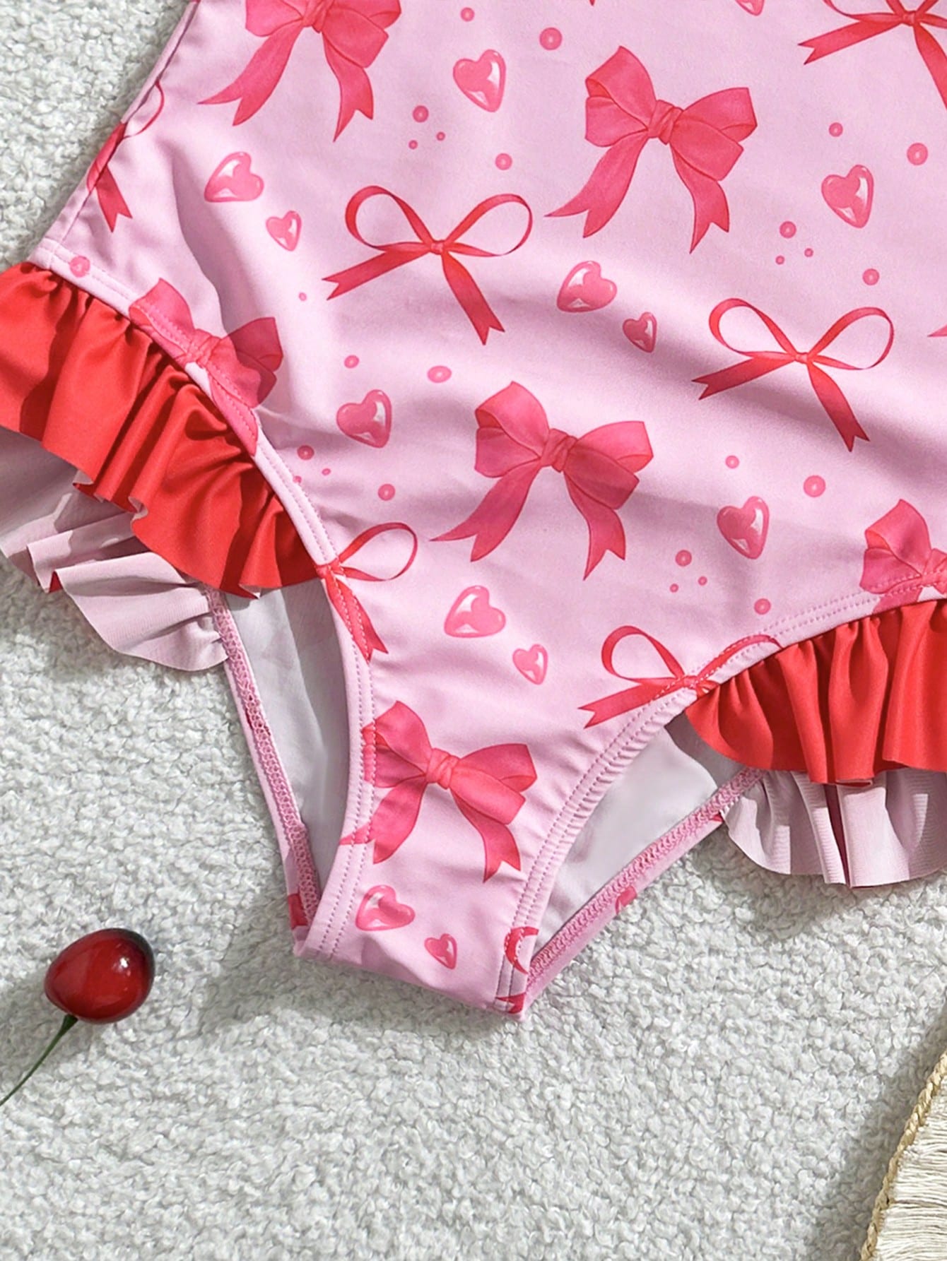 Tween girl plaid all-over print one-piece swimsuit with ruffle detail, spaghetti straps, fitted shape, and multicolor patchwork style for beach or pool wear.