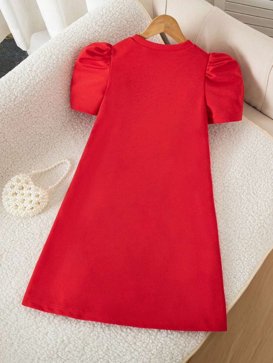 Tween girls apricot short-sleeve pleated smock dress with 3D bow decor and round neckline.