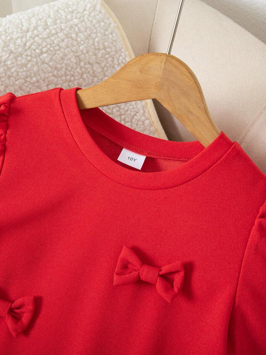 Tween girls apricot short-sleeve pleated smock dress with 3D bow decor and round neckline.