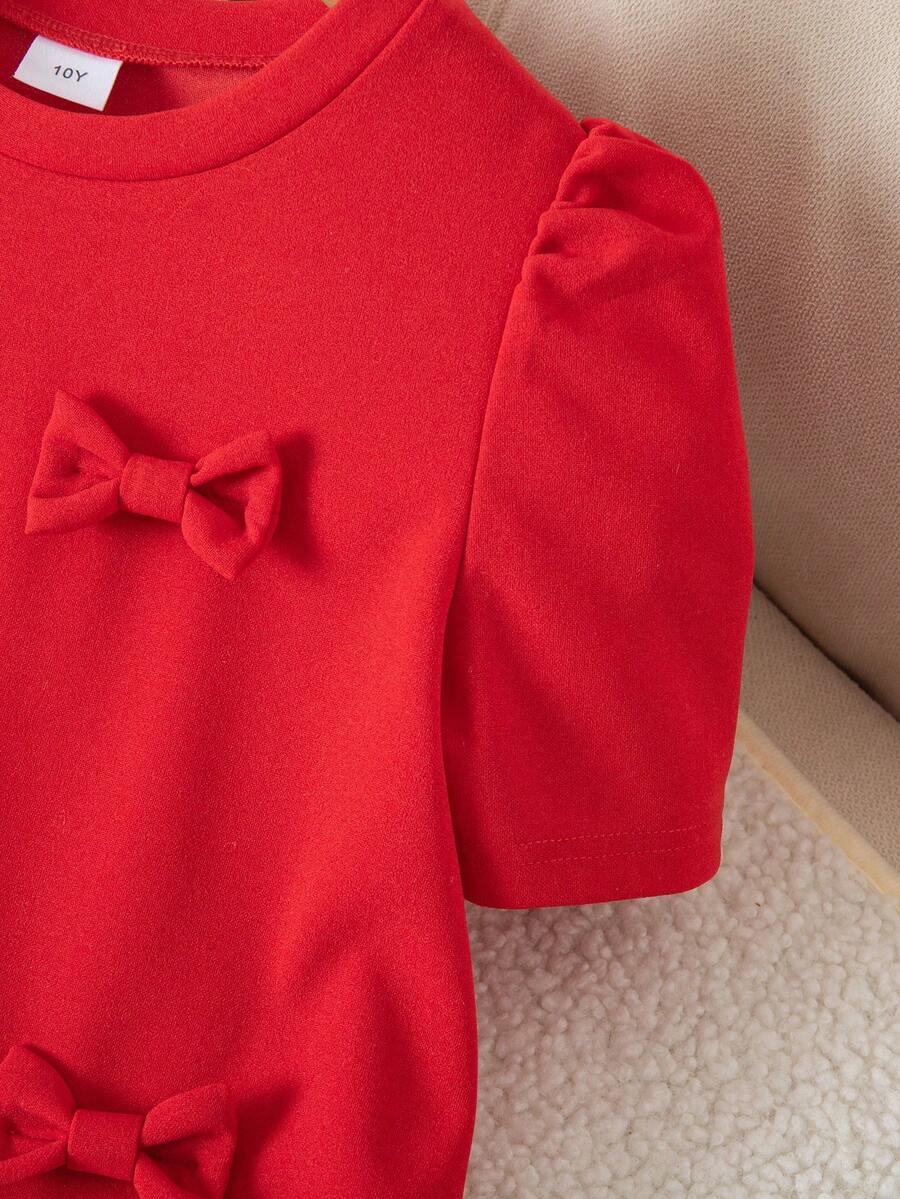 Tween girls apricot short-sleeve pleated smock dress with 3D bow decor and round neckline.