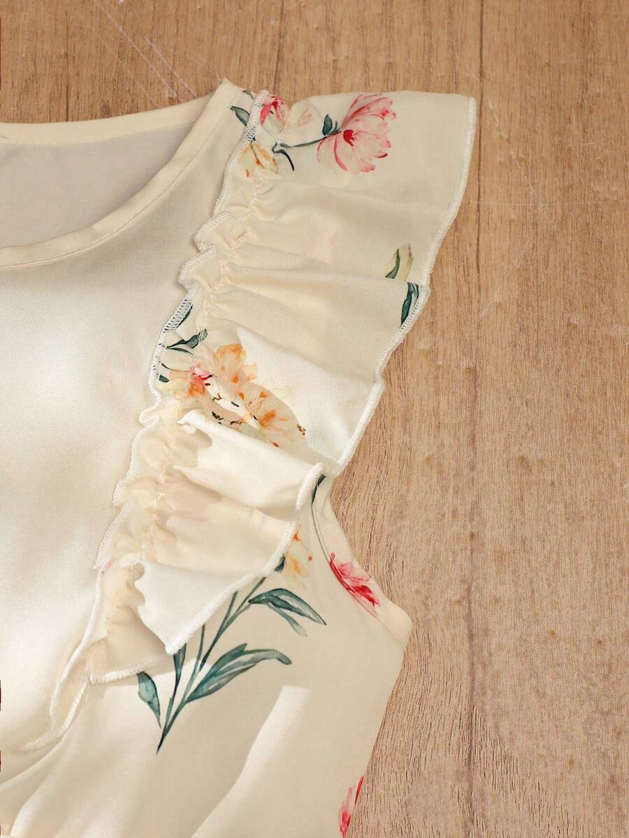 Girls sleeveless floral ruffle high waist A-line dress in champagne color with round neck and flounce hem.