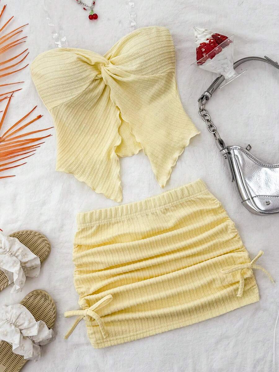 Tween girls apricot two-piece set featuring a spaghetti strap tank top and skirt with ruched lettuce trim.