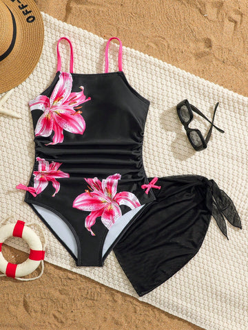 Tween girls 2-piece swimsuit in black with pink floral print, featuring spaghetti straps, bow decor, mesh detail, and a skirted mid-waist bottom. Sleeveless vacation-style swim set with medium-stretch fabric.