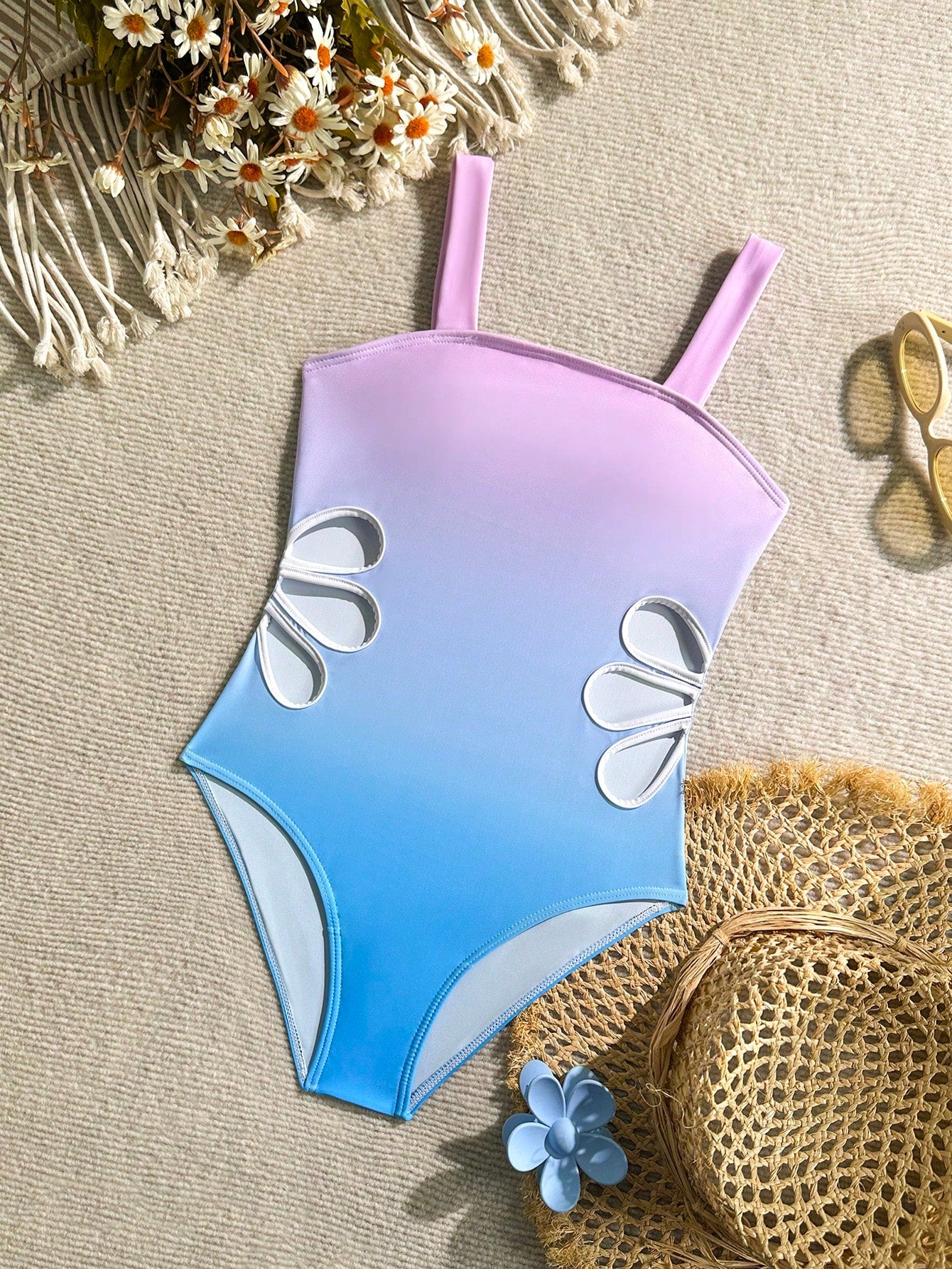 Tween girls one-piece swimsuit with a floral plant print, spaghetti straps, and a mid-waist fit in black.